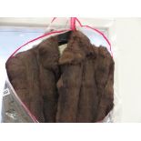 A FUR COAT TOGETHER WITH A SHEEP SKIN RUG