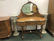 A FIVE DRAWER BOW FRONT SATIN WOOD AND INLAID REGENCY STYLE CHEST OF DRAWERS aND MATCHING DRESSING