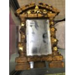 A CARVED GILTWOOD EASEL BACK MIRROR.