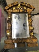 A CARVED GILTWOOD EASEL BACK MIRROR.