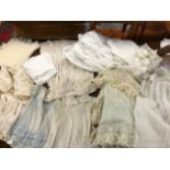 A QUANTITY OF MAINLY ANTIQUE AND LATER CHRISTENING GOWNS,SHAWL, DRESSES, BIBS IN SILK, LACE AND