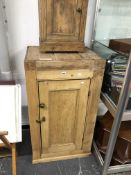 A VICTORIAN PINE PANEL DOOR CABINET AND A BEDSIDE CABINET.