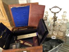 AN ANTIQUE SEVEN BOTTLE CRUET SET ON STAND, AND A WRITING BOX.