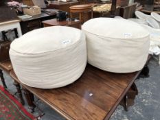 A PAIR OF LARGE POUFFES WITH HERRINGBONE PATTERN COVERS.