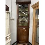 AN ANTIQUE MAHOGANY AND GLAZED FLOOR STANDING CORNER CABINET.