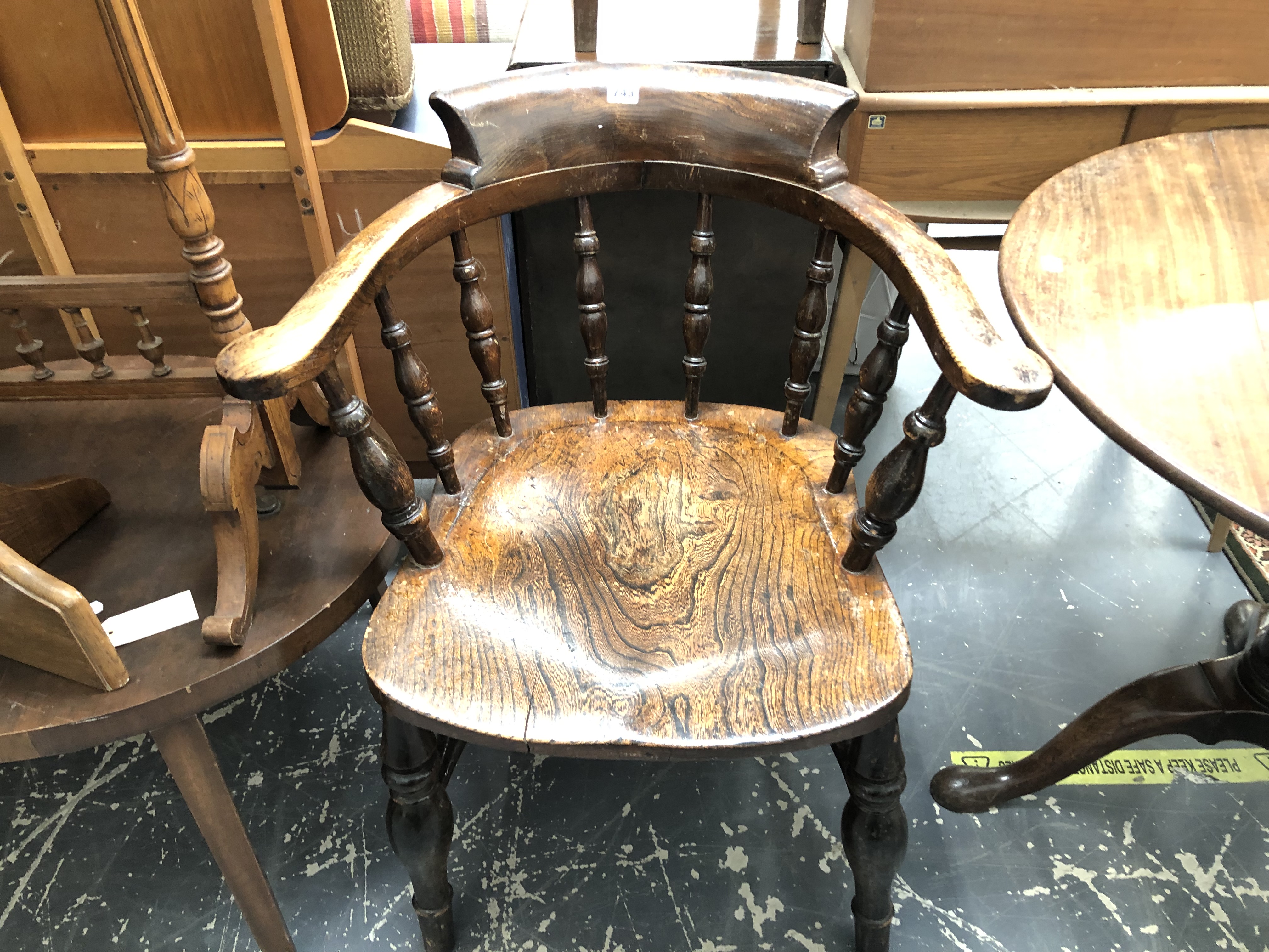 AN ANTIQUE ELM SEAT SMOKERS BOW ARM CHAIR.