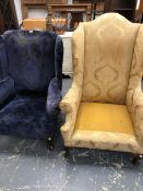 AN ANTIQUE WING BACK ARM CHAIR IN BLUE / PURPLE FLOCK.