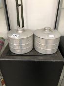 N C JOSEPH LTD, TWO ARCHIBALD KNOX STYLE ALUMINIUM CYLINDRICAL BOXES AND COVERS