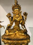 AN EASTERN GILDED BRONZE SEATED DEITY.