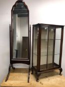 A CHEVAL MIRROR AND A SMALL DISPLAY CABINET.