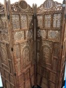 A VINTAGE EASTERN CARVED AND PIERCED FOUR FOLD SCREEN.