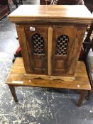 A HARDWOOD TWO DOOR SMALL CABINET AND A COFFEE TABLE. TABLE H 43 X W 89 X D 43cms.