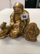 A GILT BRONZE FIGURE OF A SEATED BUDDHA WITH TOAD AND A FURTHER GILDED DEITY.