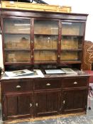 AN ANTIQUE SHOP CABINET, WITH GLAZED UPPER SECTION OVER THREE DOORS AND DRAWERS.