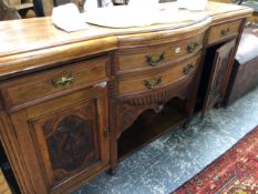 A LATE VICTORIAN BOW FRONT SIDE BOARD WITH CARVED PANEL DOORS.