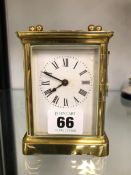A BRASS CARRIAGE CLOCK WITH KEY.