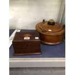 A ROUND OAK BOX WITH A PIN CUSHION TOP OVER THE DOOR INTO ITS COMPARTMENT TOGETHER WITH A MAHOGANY