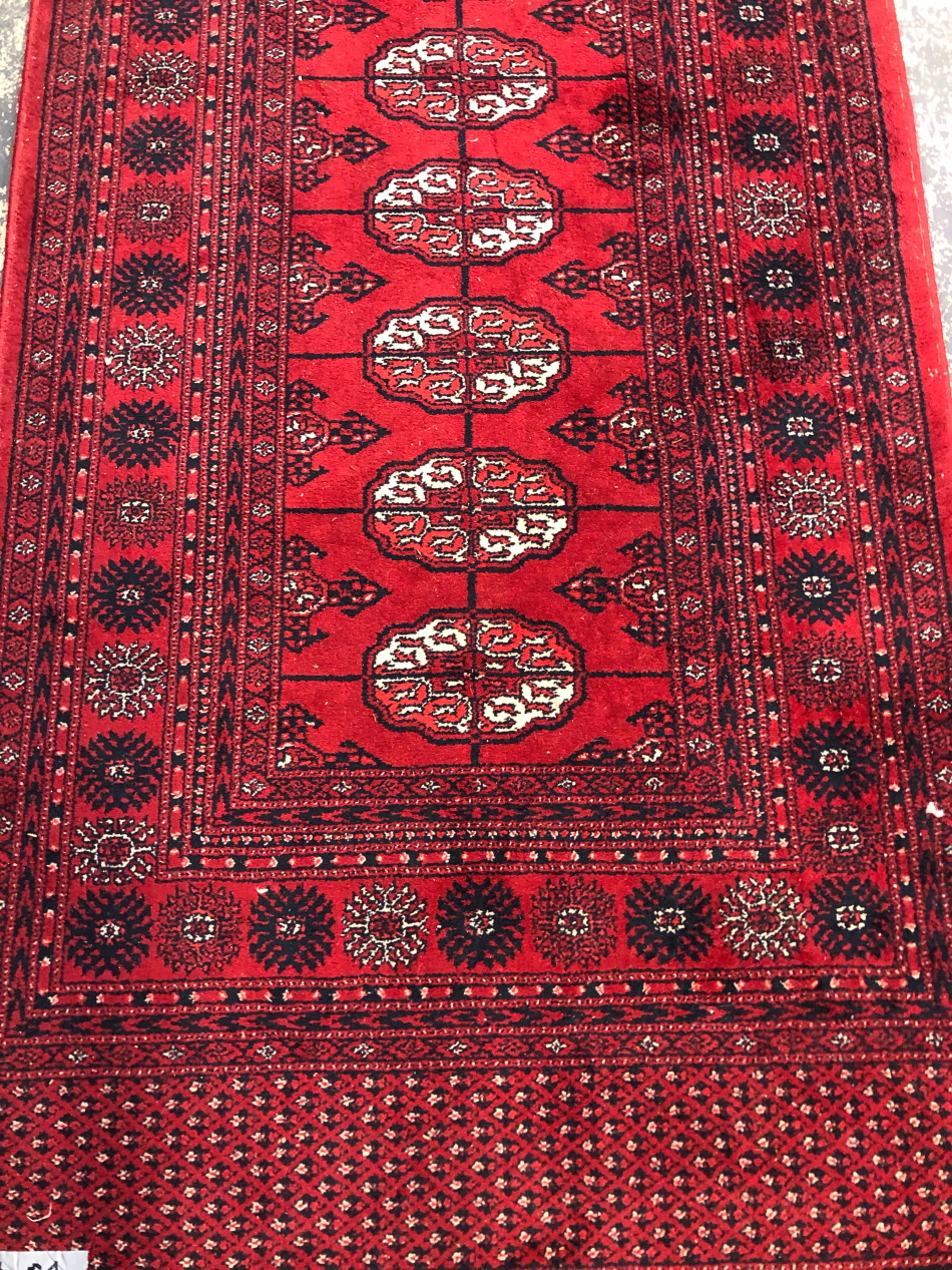 A MACHINE MADE RUG OF BOKHARA DESIGN, 197 x 90cms - Image 2 of 2