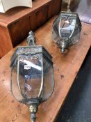 A PAIR OF HANGING BRASS AND GLASS HALL LANTERNS.