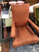 A VICTORIAN ROSE WOOD AND MAHOGANY ARM CHAIR BRASS CASTORS.