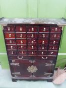A KOREAN SPICE OR HERBAL CABINET OF 27 LABELLED DRAWERS OVER A PAIR OF DOORS