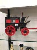 A MODEL HORSE DRAWN BLACK AND RED COACH INSCRIBED BUS IN GILT.