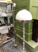 A BRASS TRIPOD STANDARD LAMP AND A CHROME STANDARD LAMP WITH DOMED MILK GLASS SHADE.