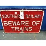 A SOUTHERN RAILWAY RED GROUND IRON SIGN BEWARE OF THE TRAINS