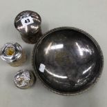 A HALLMARKED SILVER LIDDED DRESSING TABLE JAR, TWO GLASS SILVER LIDDED EXAMPLES AND A PLATED BOWL.