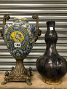 A METAL HANDLED BLUE AND WHITE PORCELAIN BALUSTER VASE TOGETHER WITH A BLACK POTTERY DOUBLE GOURD