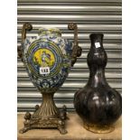 A METAL HANDLED BLUE AND WHITE PORCELAIN BALUSTER VASE TOGETHER WITH A BLACK POTTERY DOUBLE GOURD