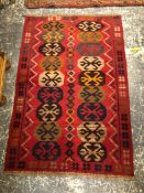 A ORIENTAL MIXED TECHNIQUE TRIBAL RUNNER TOGETHER WITH ANOTHER RUG.