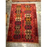 A ORIENTAL MIXED TECHNIQUE TRIBAL RUNNER TOGETHER WITH ANOTHER RUG.