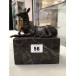 A BRONZE FIGURE OF A SEATED DEER ON A MARBLE PLINTH SIGNED L. CARVIN.