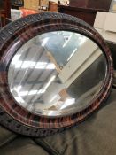 A LARGE OVAL BEVEL PLATE MIRROR.