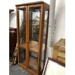 A MODERN GLAZED DISPLAY CASE. H 181 X W 80 X D 34cms.