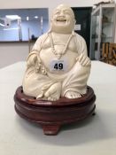 A LARGE ANTIQUE CARVED IVORY BUDDHA.