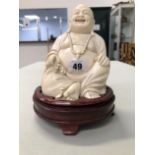 A LARGE ANTIQUE CARVED IVORY BUDDHA.
