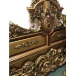 AN IMPRESSIVE CARVED AND GILT DECORATED DOUBLE BED HEADBOARD AND FOOT.