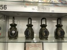 FOUR VINTAGE TILLY LAMPS.