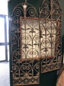 A PAIR OF ANTIQUE WROUGHT IRON WINDOW GRILLS.