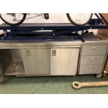 A STAINLESS STEEL INDUSTRIAL KITCHEN CABINET/ WORKBENCH.