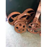 A QUANTITY OF VINTAGE CAST IRON WHEELS.