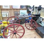 A VETERAN TYPE WOODEN WHEELED TRICYCLE WITH CANDLE LANTERN HEAD LIGHT.