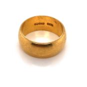 A HALLMARKED 22ct YELLOW GOLD WIDE WEDDING BAND. WIDTH 8.2mm. FINGER SIZE O. WEIGHT 9.7grms.