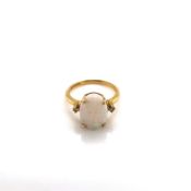 AN 18ct GOLD HALLMARKED OPAL AND DIAMOND RING. THE OVAL OPAL IN A FOUR CLAW SETTING, WITH A SMALL