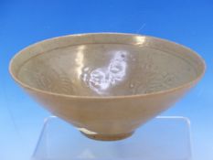 A CHINESE CELADON BOWL, THE INTERIOR MOULDED WITH ALTERNATING FLOWERS AND FOLIAGE, THE GLAZE REPUTED