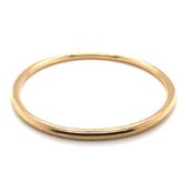 A 9ct GOLD BANGLE, DATED BIRMINGHAM 1977, 24.8grms. DIAMETER 7cms.