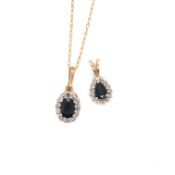 A 9ct GOLD HALLMARKED SAPPHIRE AND DIAMOND CLUSTER PENDANT SUSPENDED ON A 9ct GOLD CHAIN, CHAIN