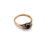 A HALLMARKED 9ct YELLOW GOLD, SAPPHIRE AND DIAMOND THREE STONE RING. FINGER SIZE N. WEIGHT 1.9grms.